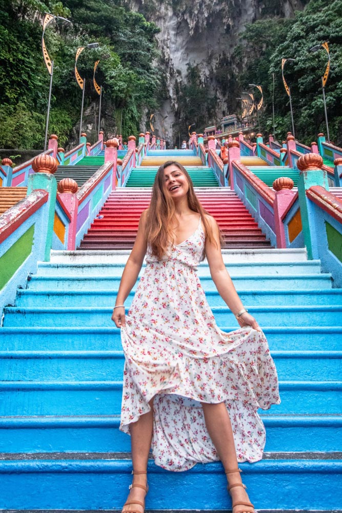 Melissa waving her dress at the Batu Caves rainbow steps