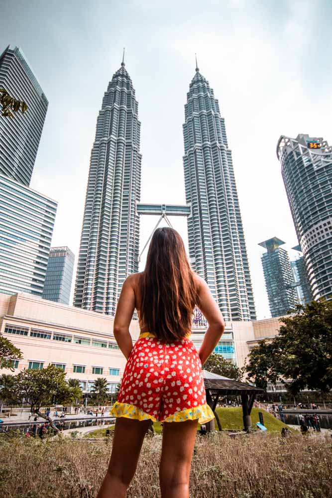 Melissa looks up at the Petronas Towers from the KLCC park.