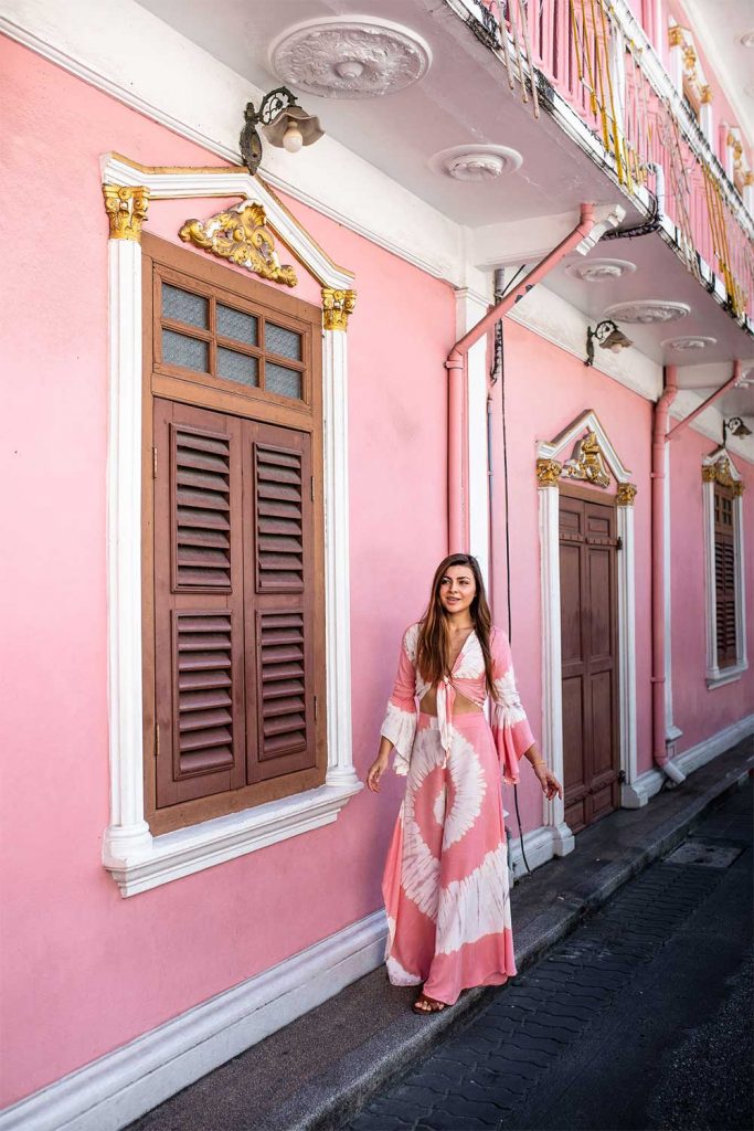 Melissa wearing a pink dress in front of a pink house in Phuket Old Town