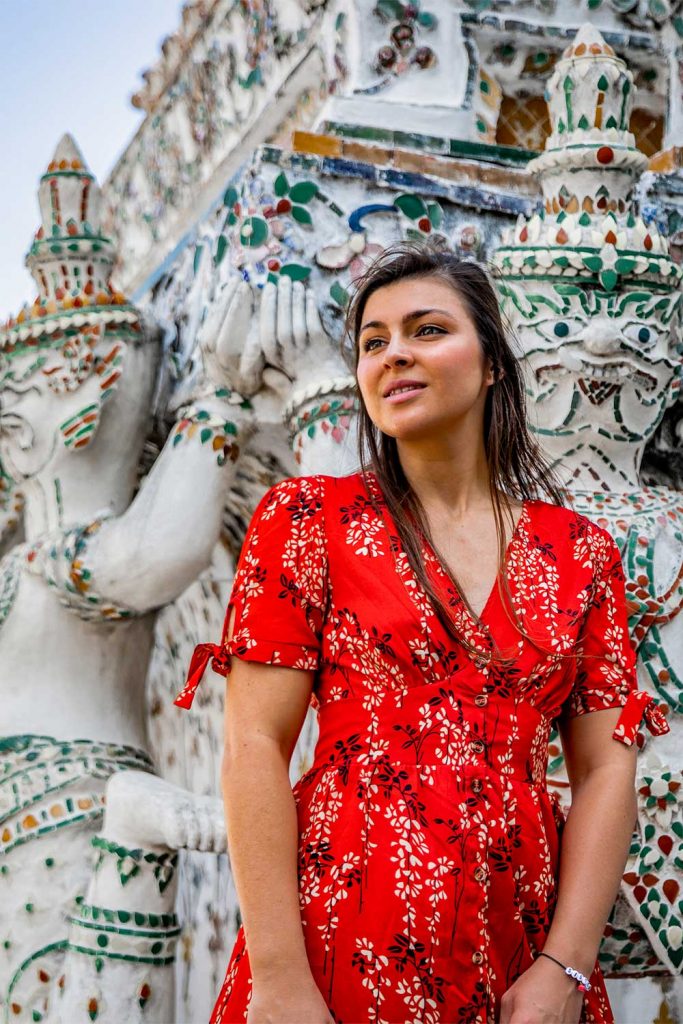 portrait of Girl Around the World in front of the tiles at Wat Arun