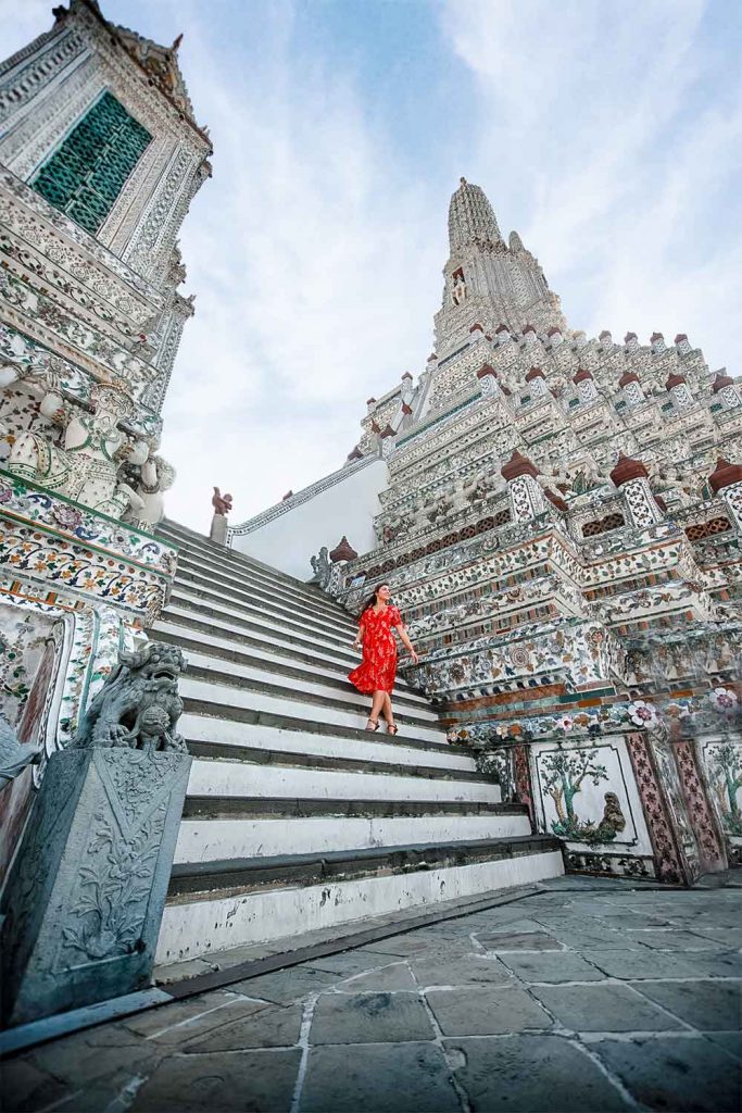 Wide angle photo with Melissa on the bottom stairs of Wat Arun