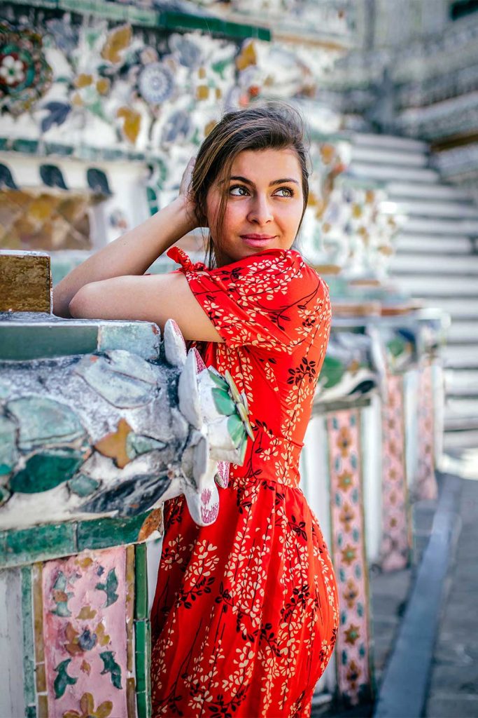 Portrait of Melissa leaning on the tiles at Wat Arun