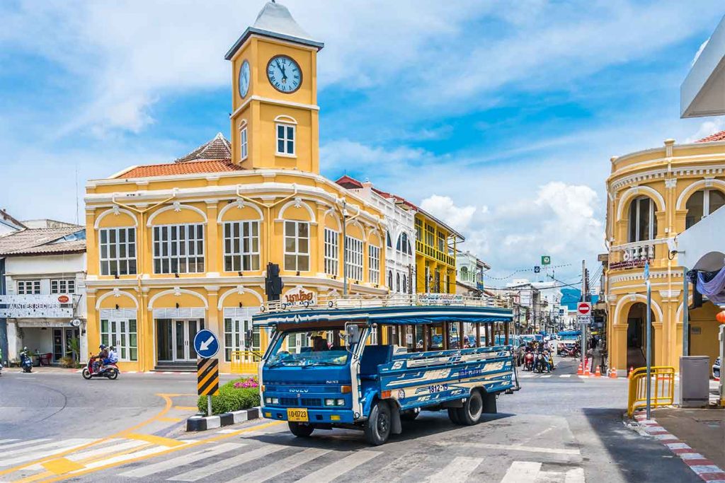 Center of Phuket Old Town with a yellow Perenakan House and a blue bus
