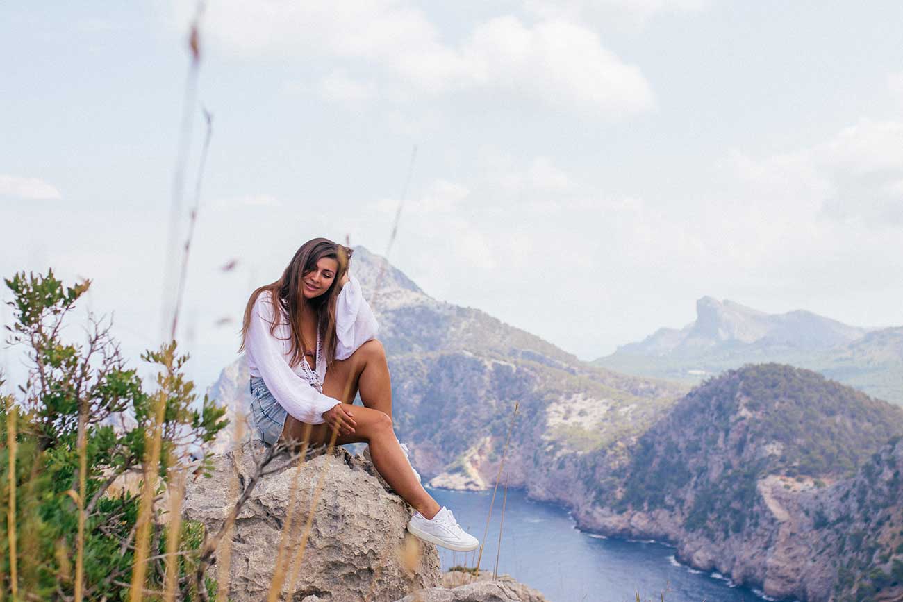 Melissa sitting on a rock with a view over the Cap de Formentor