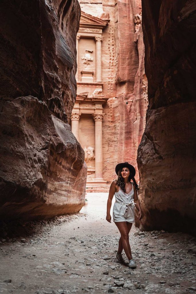 Melissa standing on the Al Siq Canyon in Petra Jordan with the Petra Treasury in the background