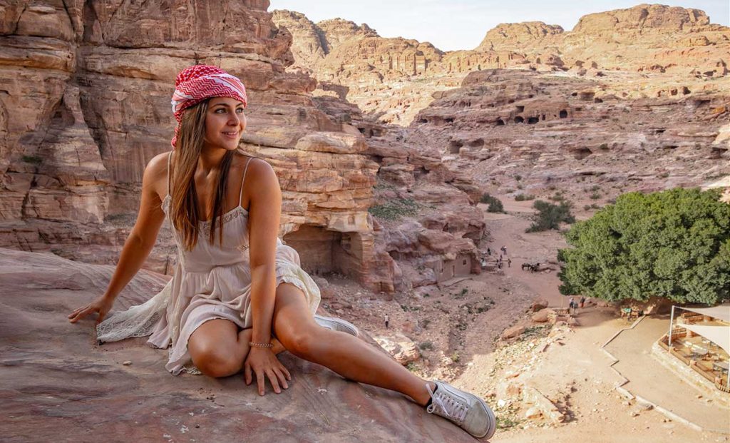 Girl Around the World sitting on a rock at Petra Jordan