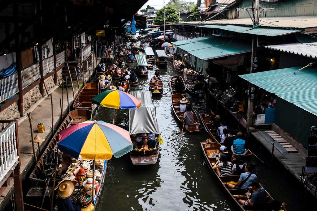 river with dozens of merchant boats at a floating market in bangkok