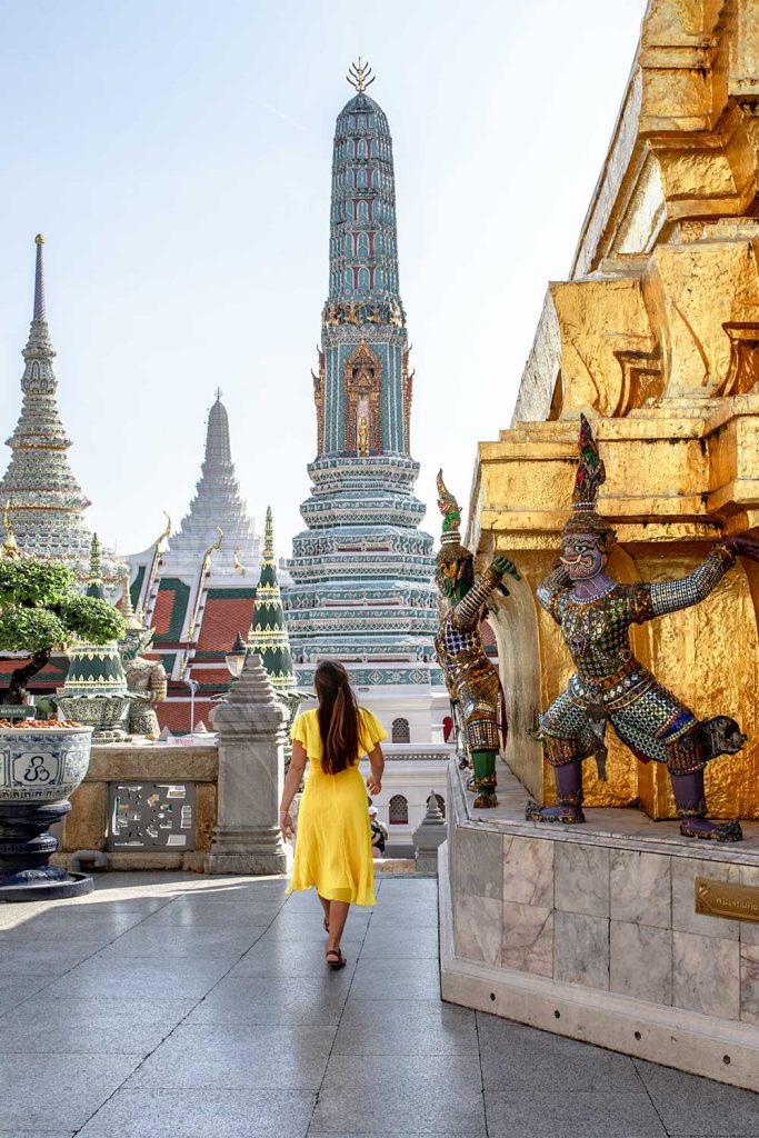 Melissa walking down a pathway in the grand palace leading to a building