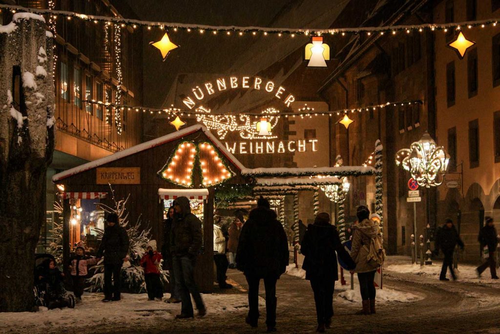 Streets of Nuremberg with people walking down the street and christmas decorations hanged up