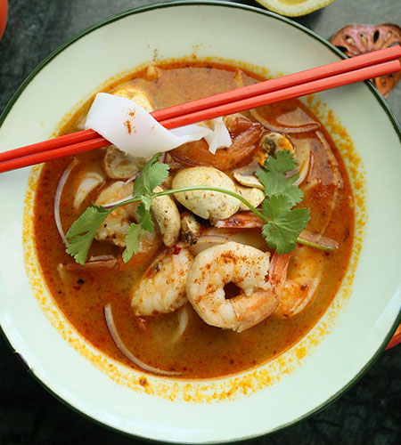 Tom Yum Soup with eating sticks on top