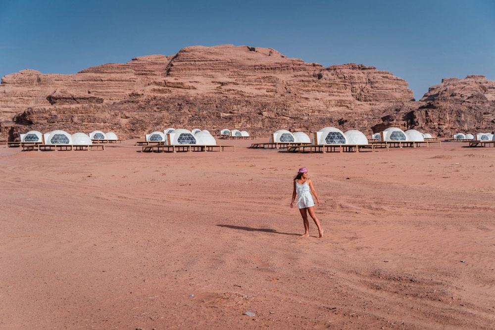 Melissa stands in front of the bubble pod rooms at a bubble hotel in the Wadi Rum.