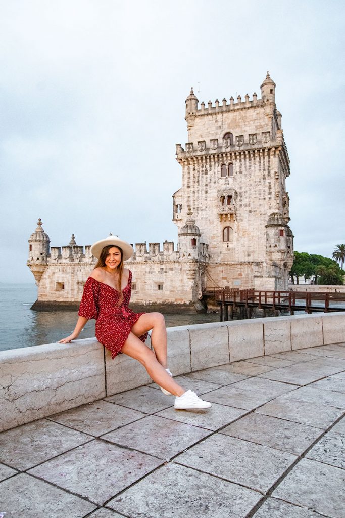 Melissa sits outside of Belem Tower in Portugal Lisbon