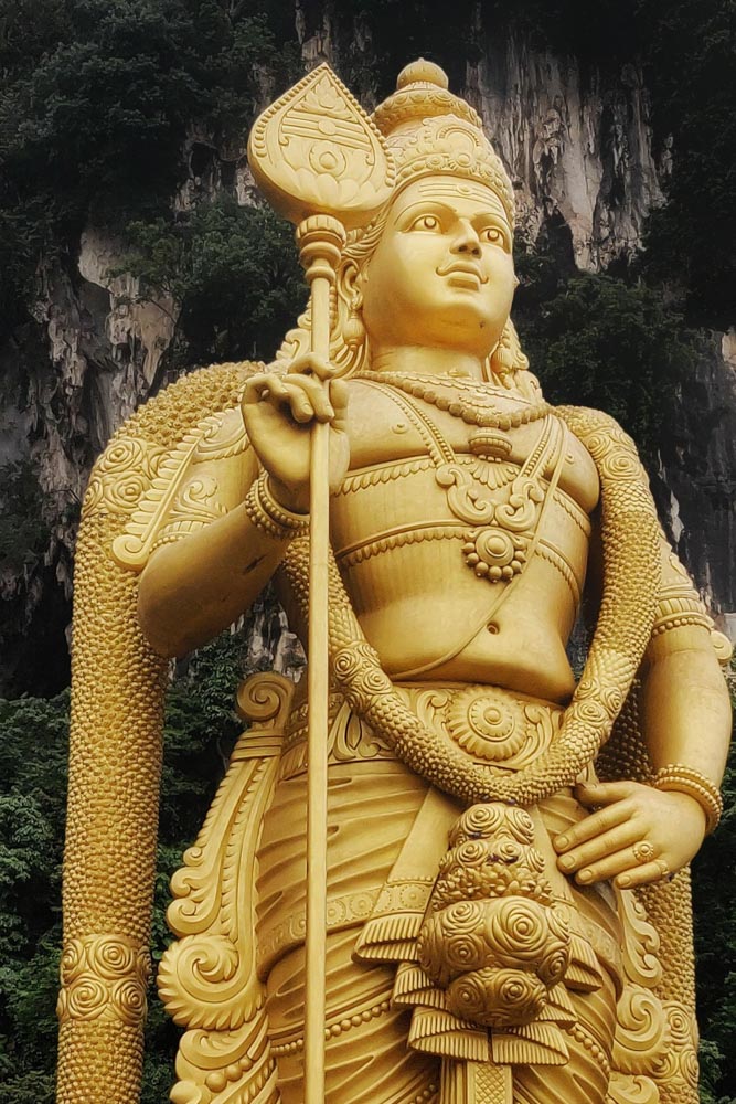 The golden status of the Hindu god Lord Murugan at the Batu Caves in Kuala Lumpur, Malaysia.