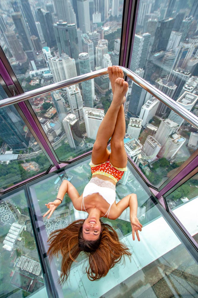 Melissa sitting upside down in the Sky Box at KL Tower in Kuala Lumpur